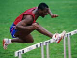 Male Hurdler in Action Photographic Print by Paul Sutton