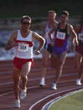 Male Runners Competing in a Track Race Lámina fotográfica