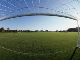 View of Soccer Field Through Goal Fotografie-Druck von Steven Sutton