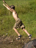 9 Year Old Boy Jumping Off a Rock into a Pond, Woodstock, New York, USA Lámina fotográfica por Paul Sutton