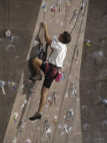 Man Wall Climbing Indoors with Equipment Lámina fotográfica
