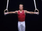 Male Gymnast Performing on the Rings Photographic Print