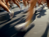 Detail of Runners Legs in Aroad Race Photographic Print by Steven Sutton