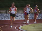 Male Runners Competing in a Track Race Lámina fotográfica