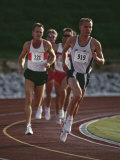 Male Runners Competing in a Track Race Lámina fotográfica