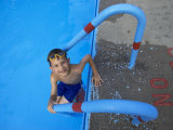 Portrait of 9 Year Old Boy Swimming in Pool, Kiamesha Lake, New York, USA Photographic Print by Paul Sutton