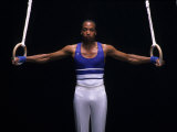 Male Gymnast Performing on the Rings Photographic Print