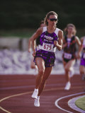 Female Runner Competing in a Track Race Photographic Print