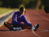 Female Runner Stretching While Training on the Track Photographic Print