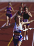 Female Runner Victorious at the Finish Line in a Track Race Photographic Print