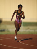Female Runner Competing in a Track Race Photographic Print