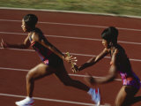 Female Runner Competing in a Relay Track Race Photographic Print