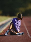 Female Runner Stretching While Training on the Track Photographic Print