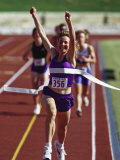 Female Runner Victorious at the Finish Line in a Track Race Photographic Print