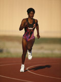 Female Runner Competing in a Track Race Photographic Print