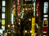 Elevated Street Scene with Lighted Signs and Crowds at Night Photographie par Paul Chesley
