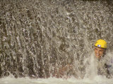 Whitewater Kayaker Pokes His Head Out from under a Small Waterfall Photographie par Skip Brown