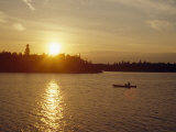 Woman and Her Dog Canoe at Sunset Photographie par Gordon Wiltsie