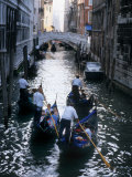 Gondoliers Steer their Gondolas with Tourists Down a Canal in Venice Photographic Print by O. Louis Mazzatenta