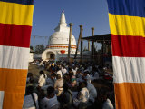Seated Crowd Gathered Outside a Buddhist Stupa Photographie par Paul Chesley