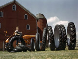 Boy Poses with Huge Rubber Tractor Tires Photographic Print by Willard Culver