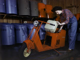 Woman Works on a Cushman Scooter for the War Effort Photographic Print by B. Anthony Stewart