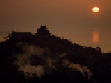 Steam Rises from Hot Springs Near Silhouetted Temple at Sunset Photographie par Paul Chesley