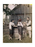 Three Adults, Dressed in Sheepskin, Stand with a Wooden Bucket Photographic Print by Wilhelm Tobien