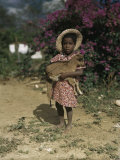 Small Girl with Dusty Bare Feet Hugs Her Tiny Goat Photographic Print by Edwin L. Wisherd