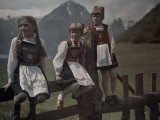 Three Norwegian Girls in Traditional Dress Linger on a Fence Photographic Print by Gustav Heurlin