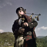 Bagpiper in Cameron Tartan Plays a Lament Photographic Print by B. Anthony Stewart