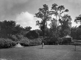 Man Plays Tennis at the Country Home of the Lowndes Family Photographic Print by Charles Martin