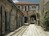 Men Chat by Stairs in a Lane Lined with Old Shuttered Warehouses Photographic Print by Edwin L. Wisherd
