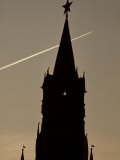 Jet Vapor Trail Passing Behind Silhouetted Spire with Russian Star Photographie par Paul Chesley