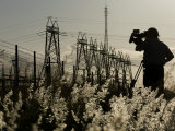 Silhouetted Photographer and Power Transmission Lines Photographic Print by Mattias Klum