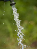 Stop Motion Image of Water Pouring from an Outdoor Well Spicket Photographic Print by Greg Dale