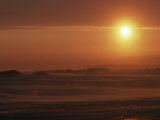 Midnight Sunlight on Blowing Snow on a Frozen Ocean Near Resolute Bay Photographie par Gordon Wiltsie