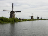 Windmills Along a Waterway in Holland Photographic Print by Mattias Klum