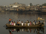 Commuters Cross a River in Saigon in a Man-Powered Boat Photographie par Paul Chesley