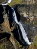 Scenic View of Waterfall and Sheer Rock Cliffs Photographic Print by Mattias Klum
