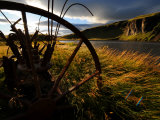 Old Piece of Farm Equipment in a Field Along a Waterway Photographic Print by Mattias Klum