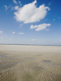 Clouds Above a Sandy Beach at Low Tide Photographie par Skip Brown