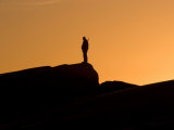 Silhouetted Hunter at Twilight Looking for Narwhals Photographie par Paul Nicklen