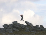 Six Year Old Boy Jumps from Rock to Rock Photographie par Skip Brown