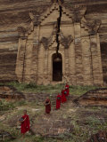 Young Monks Emerge from a Temple Carved in Rock Photographie par Paul Chesley