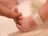 Father Touching His Newborn Sons' Foot Photographic Print by Greg Dale