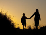 Seven Year Old Boy and His Mom Walk Hand in Hand Through Sand Dunes Photographie par Skip Brown