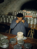 Man Tastes Cheese to Decide Flavor and Sort by Customers' Preferences Photographie par Walter Meayers Edwards