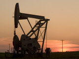 Oil Drilling Pump Silhouetted Against the Sunset in North Dakota Photographic Print by Phil Schermeister
