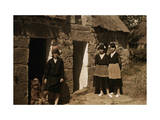 Girls Stand Outside Thatched Cottages in Brittany Photographie par Gervais Courtellemont